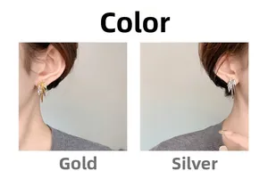 Detail of branched zircon stud earrings in gold and silver plating on ears