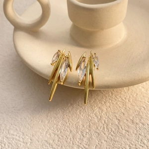 Detailed view of gold plated earrings featuring marquise-cut zircons and sharp spikes