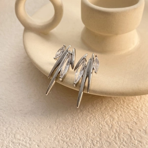 Macro detail of silver studs with marquise zircon in a bold spiky avant-garde design