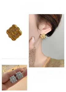 Detailed view of square braided texture earrings in gold and silver finish options