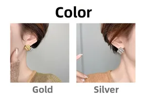 Detail of square woven earrings in gold and silver finish on a model