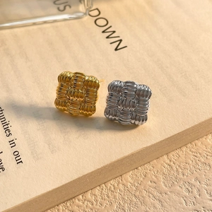 Macro detail of square braided texture earrings in gold and silver plating