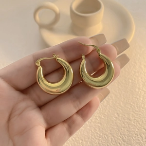 Vintage 18K gold plated thick water drop hoop earrings held in hand for premium jewelry look
