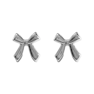 Detailed close-up of silver bow stud earrings with a polished metallic finish on white