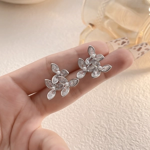 Vue détaillée des boucles d'oreilles fleur avec zircons marquise et centre perlé