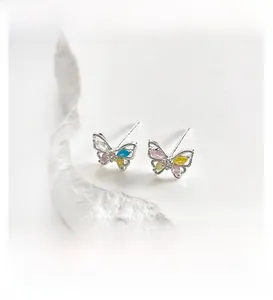 Detailed close-up of butterfly stud earrings with colorful cubic zirconia in silver
