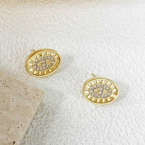 Macro detail of gold-plated hollow pig nose studs with micro-pave cubic zirconia