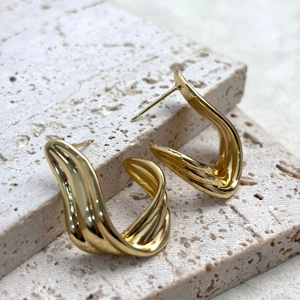 Exaggerated flowing ribbon stud earrings with 18K gold plated texture on stone base