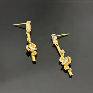 Detail of snake drop earrings in 18K gold plated copper with cubic zirconia accents