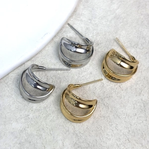 Minimalist double C-shaped wide hoop earrings in polished gold and silver finishes
