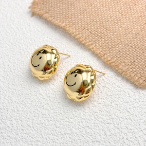 Quilted gold smile face stud earrings with modern metallic finish and glossy texture