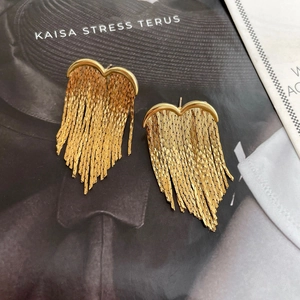 Detail of 18K gold plated heart earrings with elegant long metal snake chain tassels