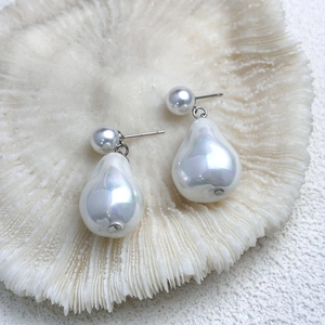 Macro shot of S925 silver stamp on baroque pearl drop earrings with iridescent finish