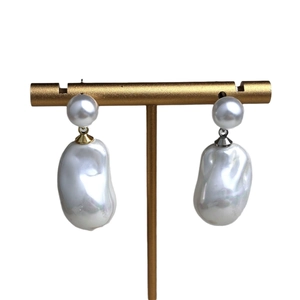 French Baroque pearl drop earrings in gold and silver finish on T-shaped stand