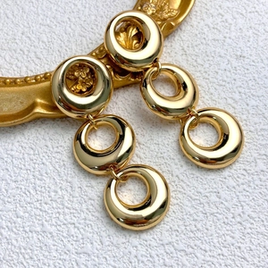 Minimalist gold triple interlocking circle drop earrings with high-polish mirror finish