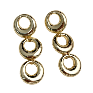 Exaggerated gold geometric triple hoop earrings with a polished metallic mirror finish
