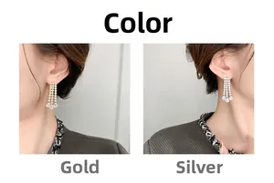 Detail of elegant gold and silver tassel earrings with sparkling teardrop rhinestones