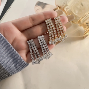 Sparkling long tassel earrings with three rows of cubic zirconia in gold and silver finish