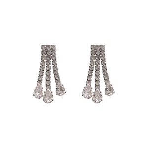 Detail of silver tassel earrings with high-clarity rhinestones and pear-cut drops