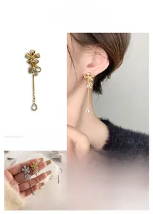 Detailed view of long flower tassel earrings with sparkling zircon drop pendants
