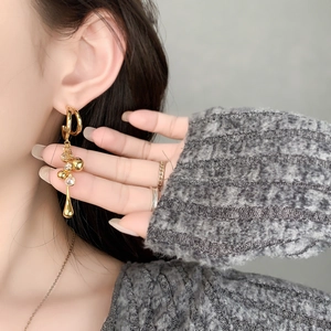 Elegant 18K gold-plated C-link tassel earrings with rhinestones worn by a model