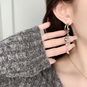 Silver chain tassel earrings with interlocking circles and teardrop metal pendants