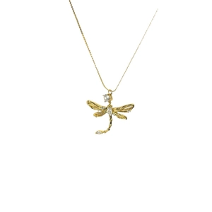 Elegant gold dragonfly pendant necklace featuring sparkling cubic zirconia on a white background