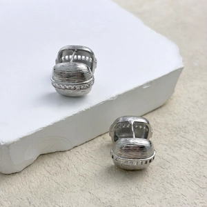 Elegant silver oval hoop earrings with brushed texture and zircon inlay on white stone