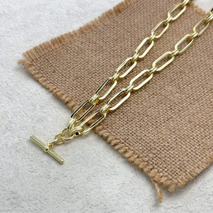 Detailed macro view of 14K gold-plated paperclip chain necklace with toggle clasp