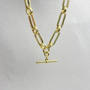 Detailed close-up of 14K gold plated brass chain necklace with minimalist OT toggle clasp