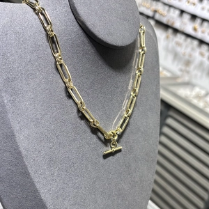 14K gold plated brass paperclip chain necklace with a classic toggle clasp on a display stand