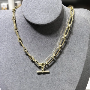 Macro shot of 14K gold-plated paperclip chain necklace with a T-bar OT toggle clasp