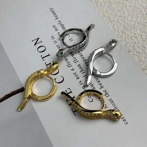 Snake hoop earrings in gold and silver plating with white cubic zirconia and green eyes