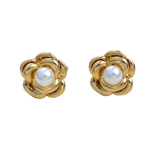 Detail of camellia flower earrings in 18K gold plated metal with pearl center inlay