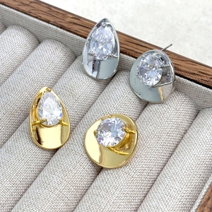 Detail of 14K gold and silver plated stud earrings set with large faceted zircon stones