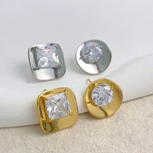 Macro detail of high-purity cubic zirconia stud earrings in gold and silver settings