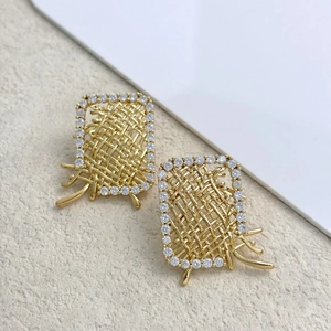 Detail view of gold woven texture earrings with pavé set sparkling crystal borders