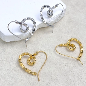 Minimalist heart-shaped stud earrings in gold and silver with textured faceted design