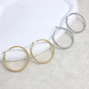 Minimalist 18K gold plated and silver large hoop earrings with snap closure on ceramic tray