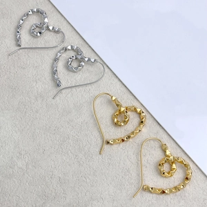 Minimalist heart-shaped geometric stud earrings in polished gold and silver finishes