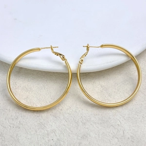 Detailed view of large 18K gold plated round hoop earrings with polished metal texture