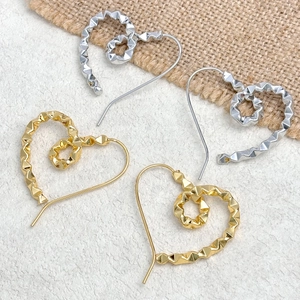 Minimalist geometric heart earrings set in gold and silver finish with metallic texture