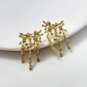 Elegant gold leaf earrings with tassel zircon chains on a clean white background
