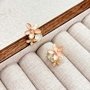 Pink enamel flower stud earrings with zircon in a wooden jewelry display box