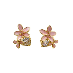Detail of 18K gold plated earrings with pink enamel flowers and sparkling zircon stones