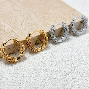 French style 18K gold plated and silver twisted chain hoop earrings on stone display