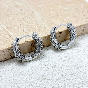 Detail of 18K gold plated hoop earrings with French irregular wire-wrapped texture on stone