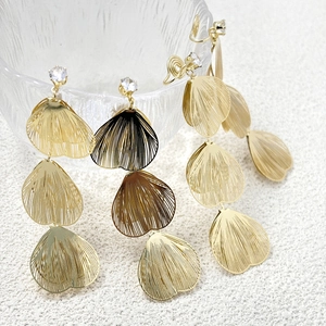 Macro view of gold-plated geometric petal earrings with zircon and hollow metal details