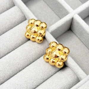 Detail view of 18K gold plated geometric spherical stud earrings in square cluster design