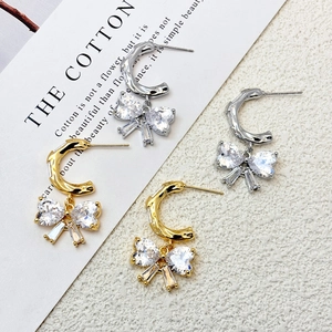 Elegant gold and silver bow drop earrings featuring heart-shaped sparkling crystals